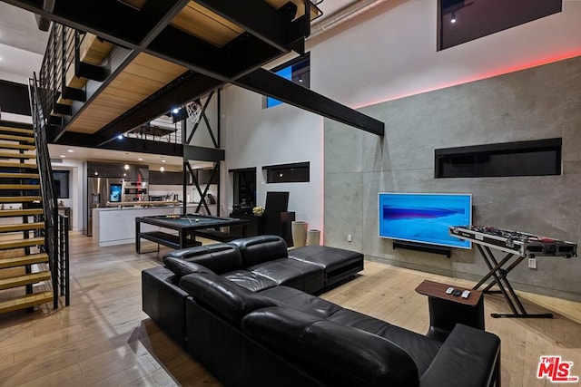 living room featuring a high ceiling and hardwood / wood-style floors