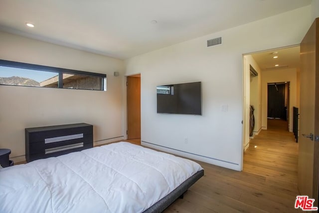 bedroom with hardwood / wood-style flooring