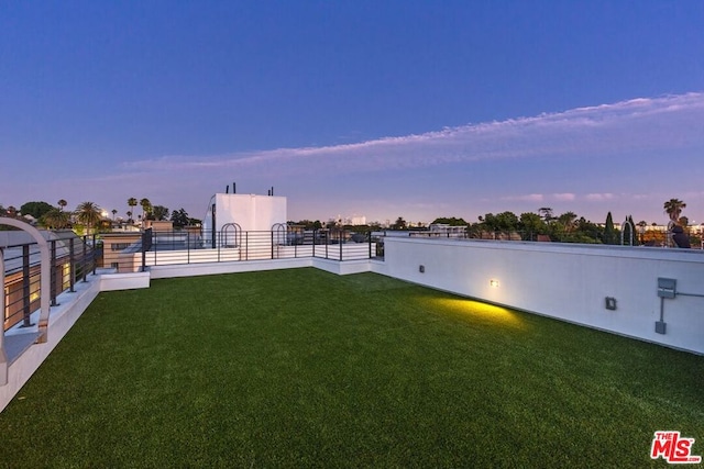 view of yard at dusk