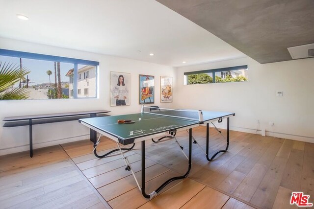 game room with light hardwood / wood-style flooring