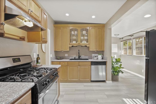 kitchen with light brown cabinetry, sink, and stainless steel appliances