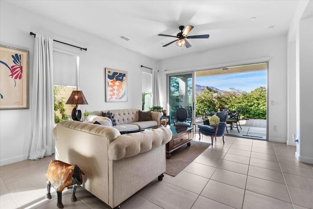 tiled living room with ceiling fan