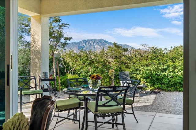 balcony with a patio area and a mountain view