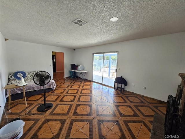 unfurnished room with a textured ceiling