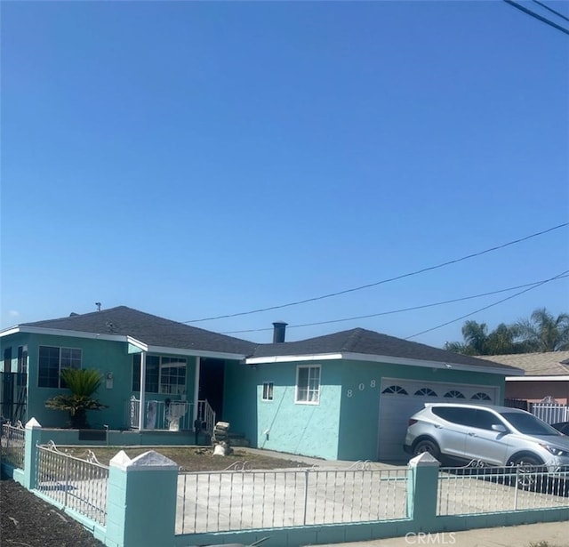 back of house featuring a garage