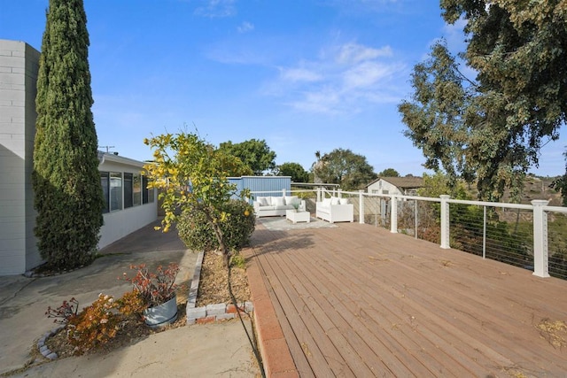 wooden terrace featuring outdoor lounge area and a patio