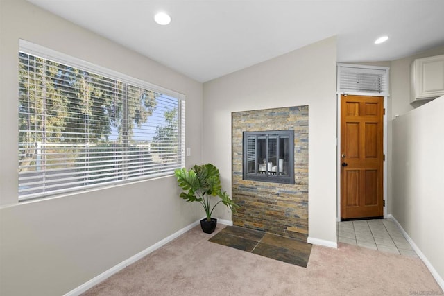 unfurnished living room with vaulted ceiling and light carpet