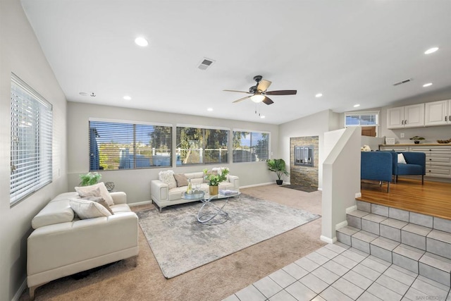 carpeted living room featuring ceiling fan