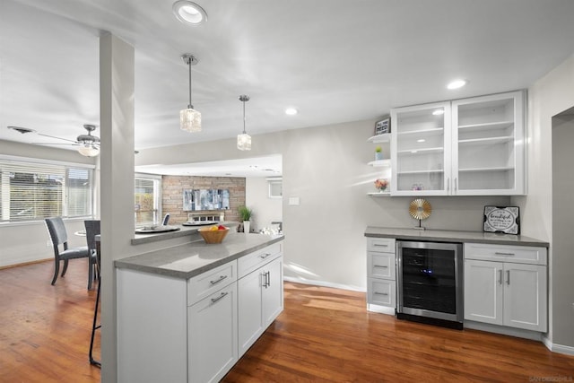 kitchen featuring white cabinets, dark wood-type flooring, beverage cooler, and ceiling fan