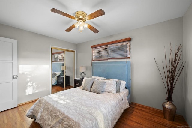 bedroom with hardwood / wood-style floors, ceiling fan, and a closet