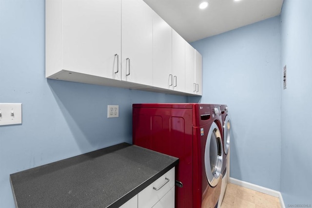 laundry area featuring cabinets and washer and clothes dryer