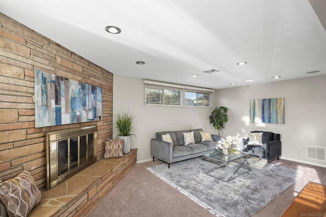 living room with a large fireplace and carpet