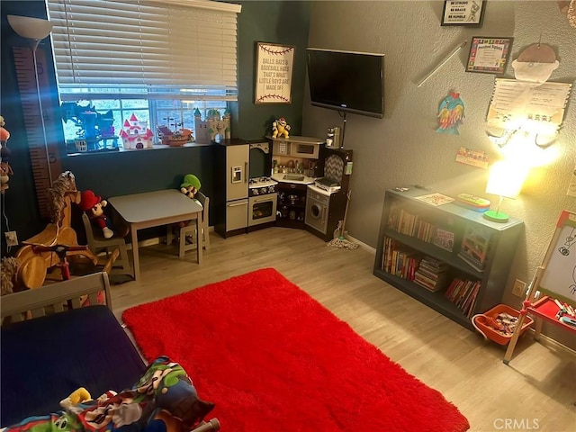 recreation room featuring light hardwood / wood-style flooring