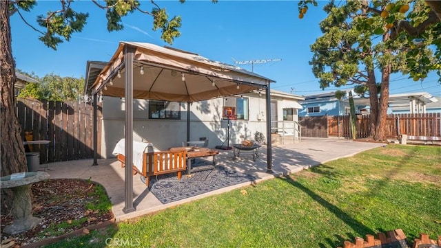 rear view of house with a patio area and a lawn