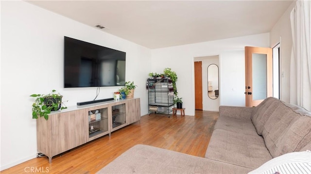 living room with light hardwood / wood-style floors and french doors