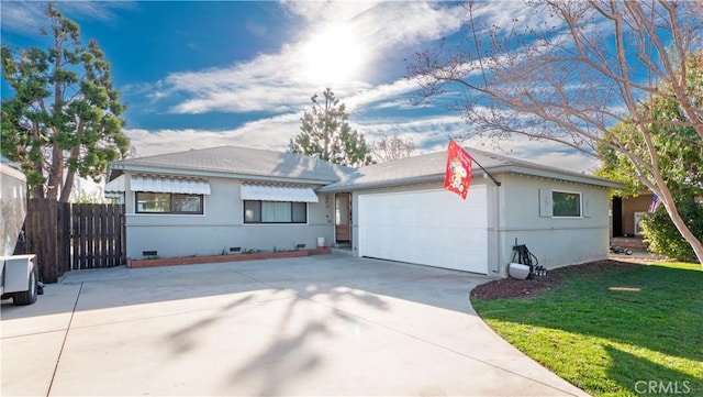 ranch-style home with a front lawn and a garage