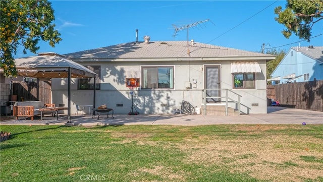 rear view of house with a yard and a patio