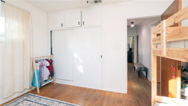 bedroom with hardwood / wood-style flooring