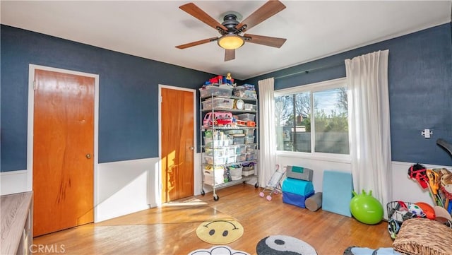 rec room featuring light hardwood / wood-style floors and ceiling fan