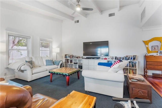 living room with ceiling fan and beam ceiling