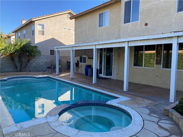 view of pool with a patio and an in ground hot tub