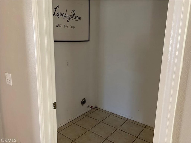 laundry area with light tile patterned flooring