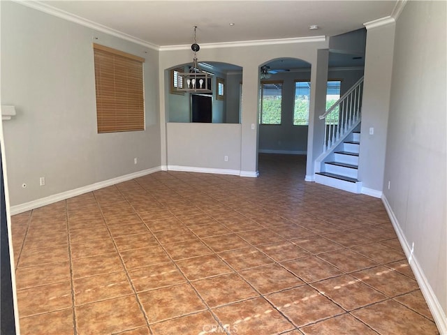 spare room with ceiling fan, tile patterned floors, and crown molding