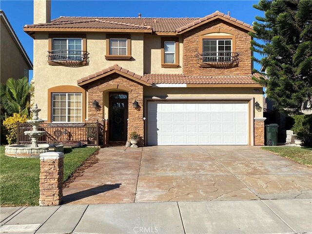 mediterranean / spanish-style home with a garage