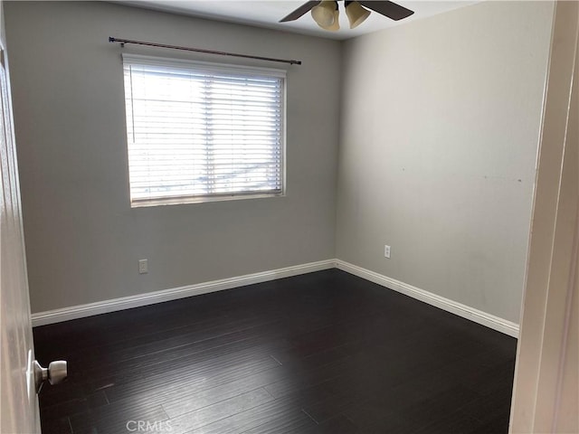 unfurnished room with ceiling fan and dark hardwood / wood-style flooring