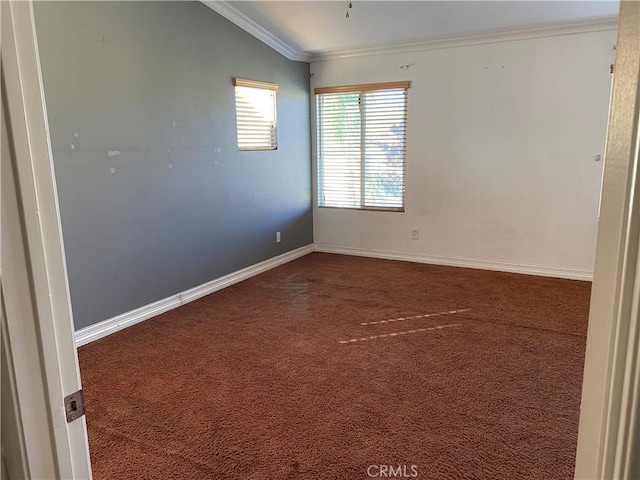 carpeted empty room featuring vaulted ceiling and crown molding