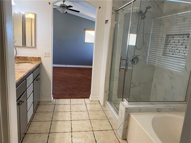 bathroom featuring ceiling fan, independent shower and bath, tile patterned flooring, lofted ceiling, and vanity