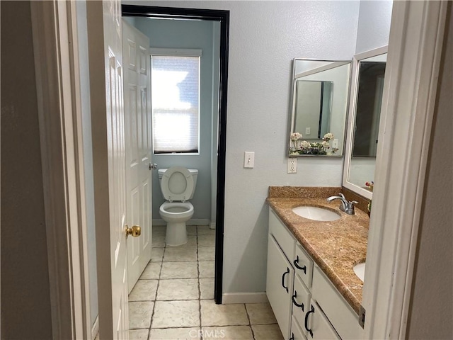 bathroom with tile patterned floors, vanity, and toilet