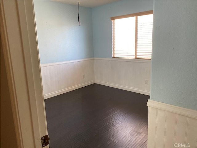 empty room with dark hardwood / wood-style floors