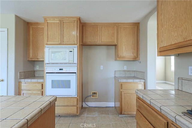 kitchen with white appliances and tile counters