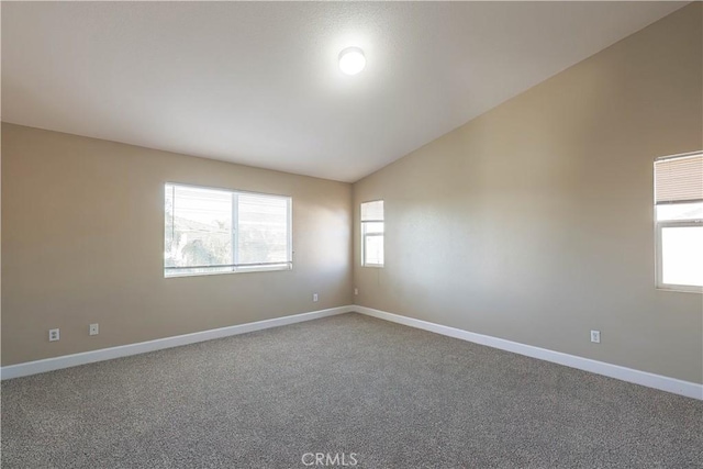 unfurnished room featuring vaulted ceiling and carpet flooring