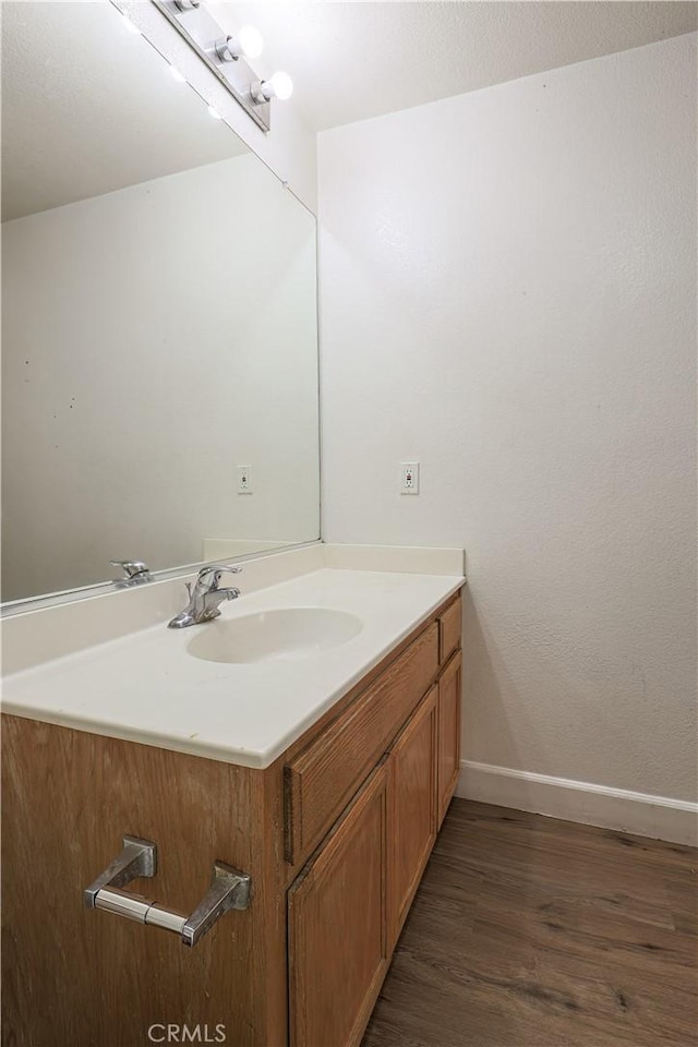 bathroom featuring vanity and hardwood / wood-style flooring