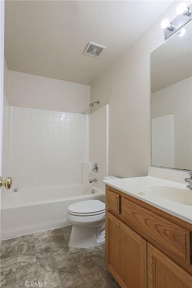 full bathroom featuring toilet, vanity, bathtub / shower combination, and a textured ceiling