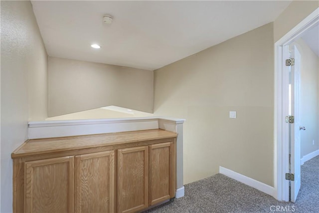 hallway with carpet floors