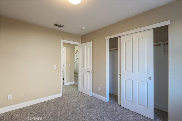 unfurnished bedroom featuring a closet and carpet flooring