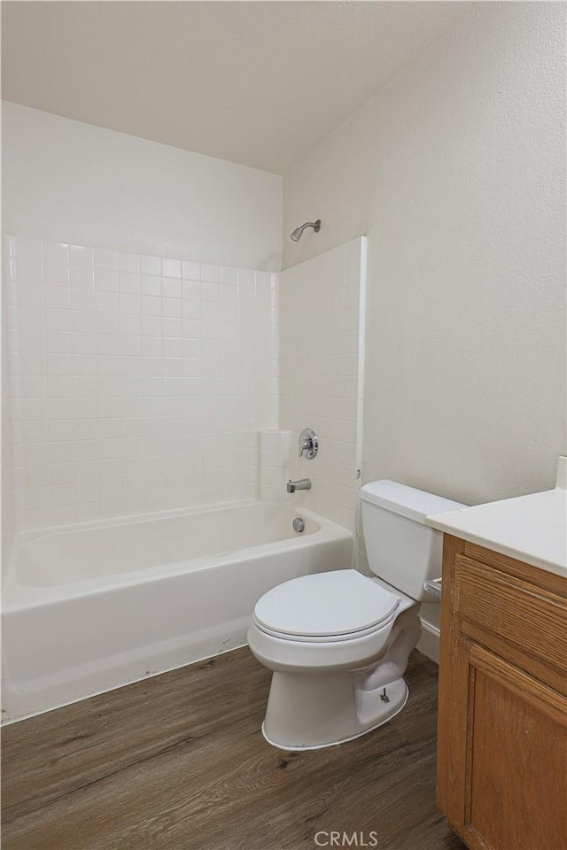 full bathroom with toilet, vanity, shower / bathing tub combination, and hardwood / wood-style floors