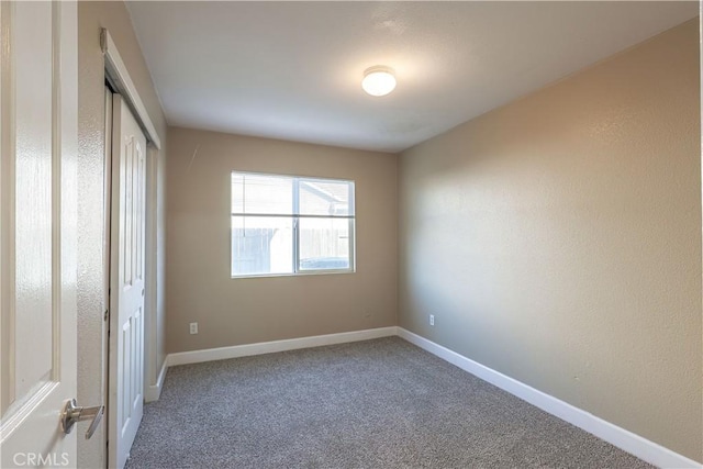 unfurnished bedroom featuring carpet floors and a closet