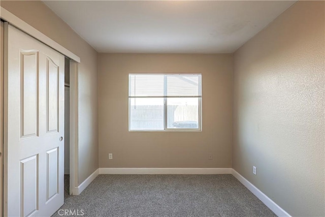 unfurnished room with carpet flooring