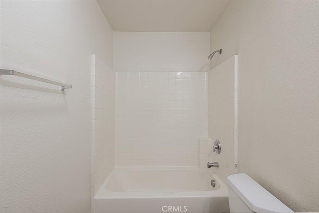 bathroom featuring shower / bathtub combination and toilet