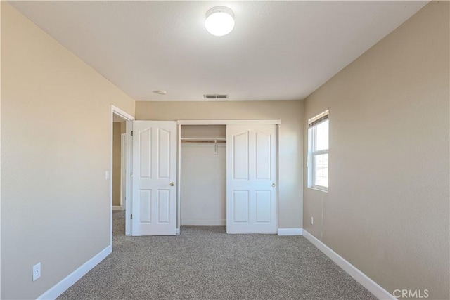 unfurnished bedroom featuring carpet floors and a closet