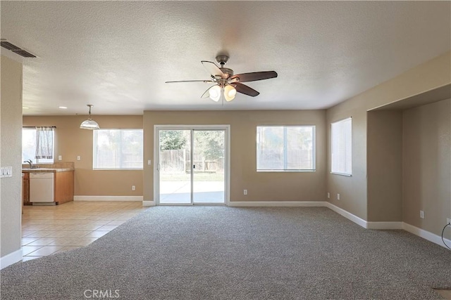 interior space with ceiling fan, light colored carpet, and sink