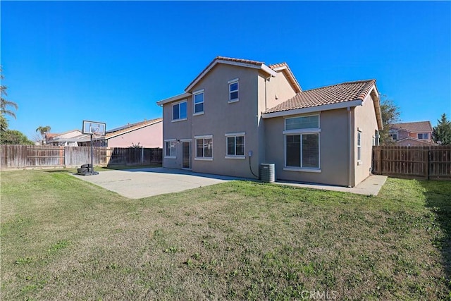 rear view of property with central AC, a yard, and a patio