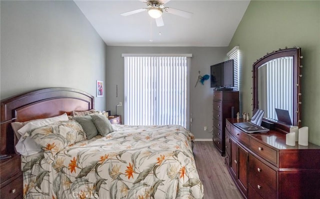 bedroom with ceiling fan, lofted ceiling, and light hardwood / wood-style flooring