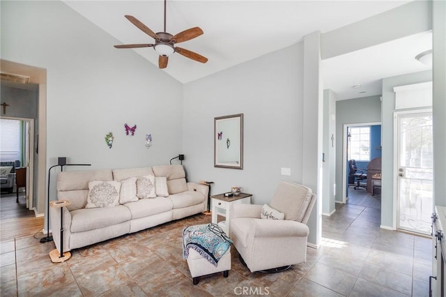 living room featuring ceiling fan and lofted ceiling