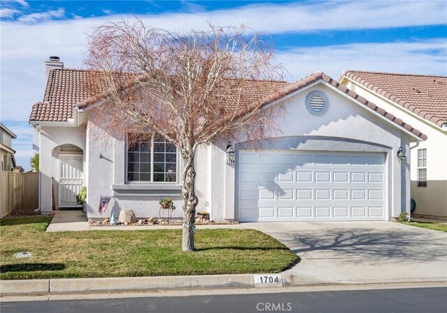 view of front of house featuring a front yard and a garage