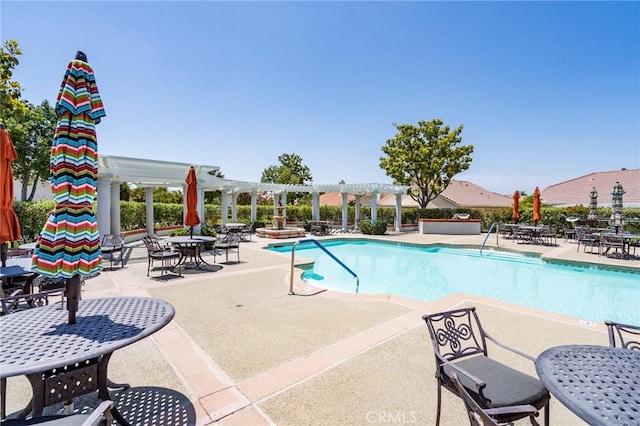 view of swimming pool featuring a patio and a pergola